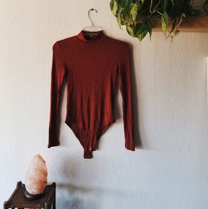 Burnt orange body suit